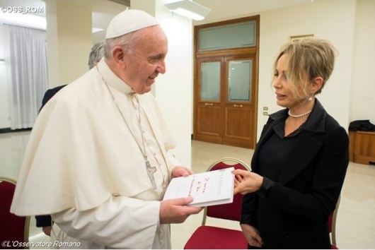 Pope Francis receives the book “The Name of God is Mercy” from Marina Berlusconi, the President of the Mondadori Group, on Monday evening in the Casa Santa Marta