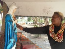 Mama Adolfia Kaize sedang mengusap wajah Arca Bunda Maria di yonggo usai kerja bakti membersihkan areal yonggo di Stasi Sirapuh. Foto. Agapitus.Batbual